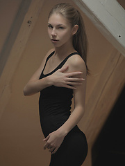 Watch her strip out of a black cat suit and make herself cum