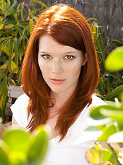 Redhead Mia Solis posing outside