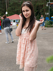 Amidst the grassy plain, under a tree,   Lilian strips her white dress and bares   her slender nubile body with soft, fair   skin in front of the camera.