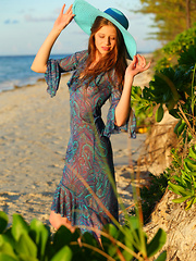 An idyllic afternoon by the beach with the fun and playful Nicole K, frolicking naked and happy on the sandy shore.